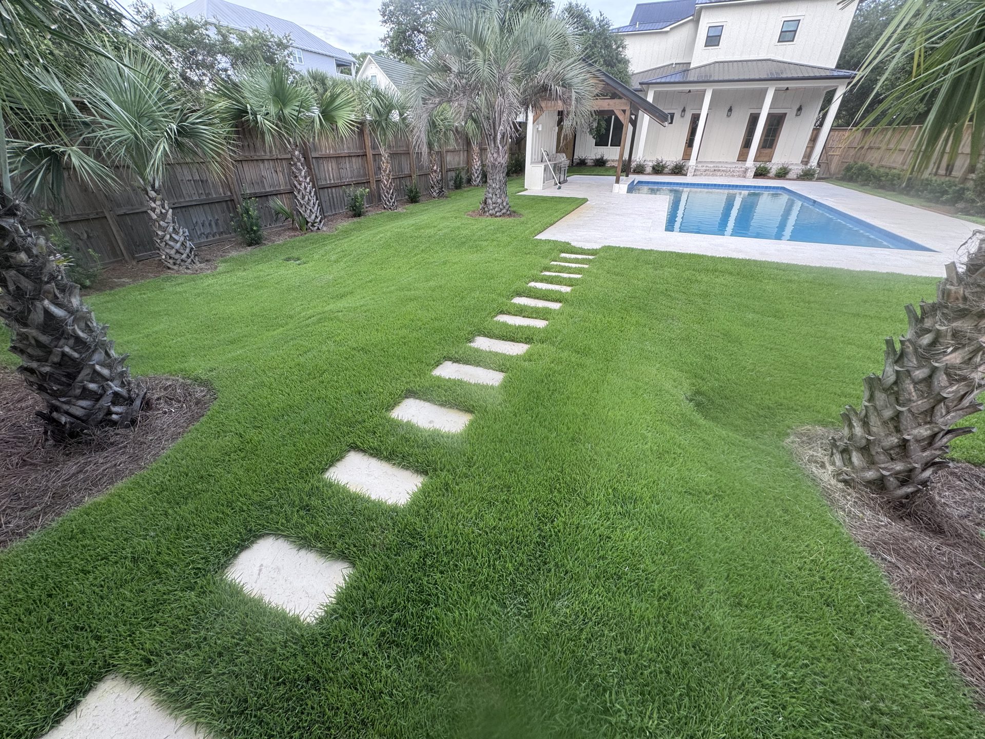 Detailed residential landscape with layered plantings and clean edges