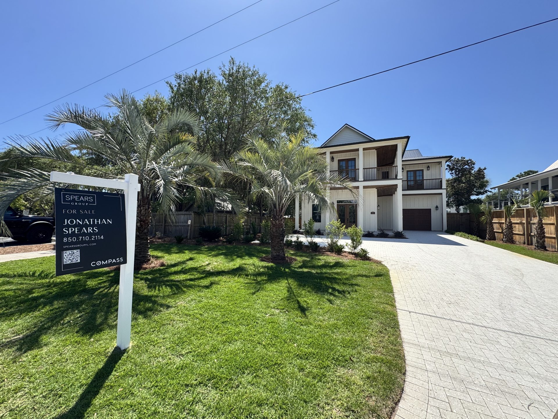Coastal residential landscape with palm cluster and bed refresh